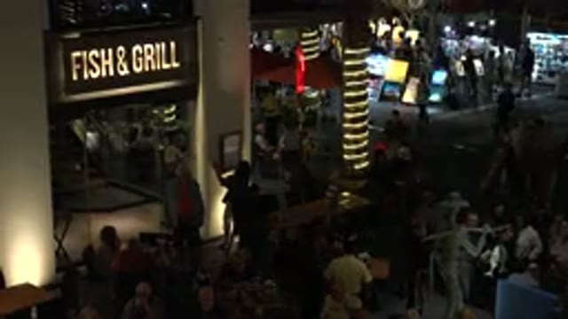 LOS CABOS MEXICO-2019: People Sitting In A Food Court At Night Near Some Stores