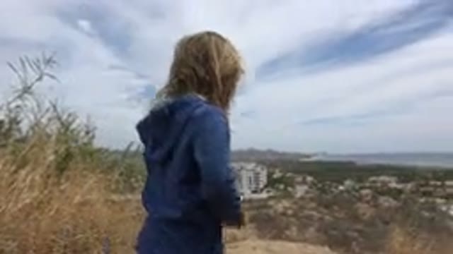 LOS CABOS MEXICO-2019: Blonde Kid on Hilltop with Women and Dog