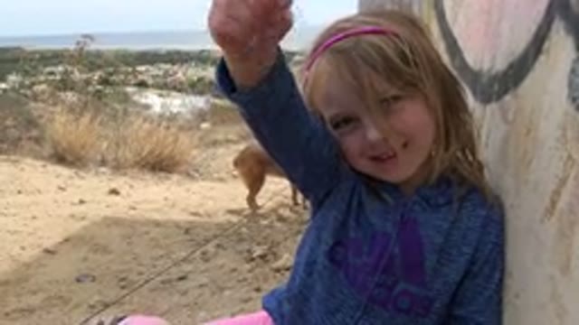 LOS CABOS MEXICO-2019: Little Girl Shows What Appears To Be A Piece Of Broken Glass
