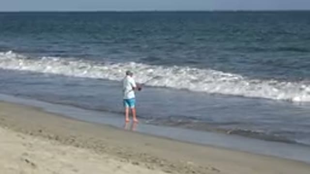 LOS CABOS MEXICO-2019: Man Fishing On Beach Seaside