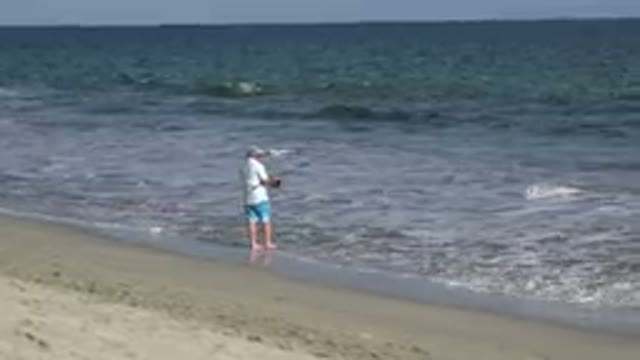 LOS CABOS MEXICO-2019: A Man Is Going Fishing At The Huge Beach On A Pretty Day