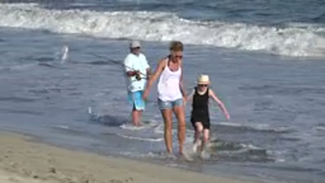 LOS CABOS MEXICO-2019: Woman Wearing White Shirt Walks With Girl Wearing Black