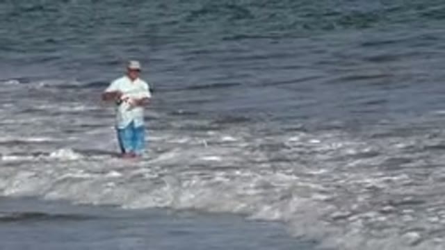 LOS CABOS MEXICO-2019: A Man In A Shirt Fishing On The Seashore With His Rod