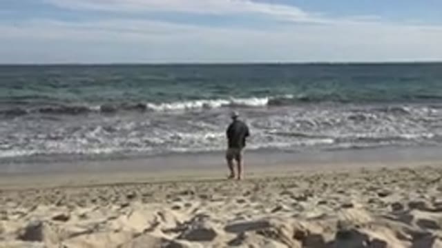 LOS CABOS MEXICO-2019: Man On Beach Walks Towards The Ocean During The Day