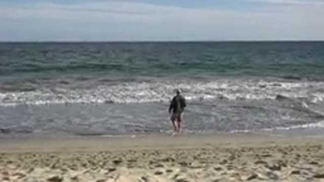 LOS CABOS MEXICO-2019: Beach Fishing Man Casting Rod Waves Hat