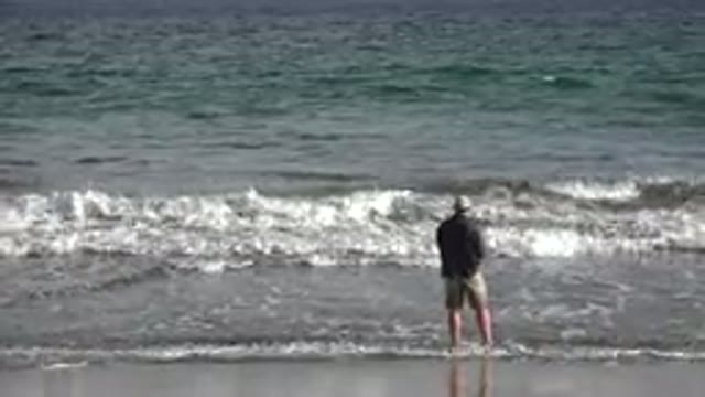 LOS CABOS MEXICO-2019: A Man Playing With Waves On A Windy Beach