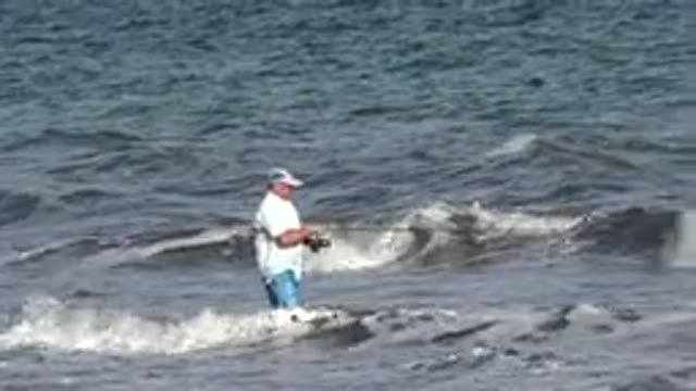 LOS CABOS MEXICO-2019: Man In Blue Tries Catching The Tide With His Fishing Rod