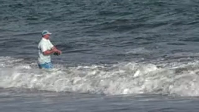 LOS CABOS MEXICO-2019: Fisherman With A White Shirt Fishing At The Beach During