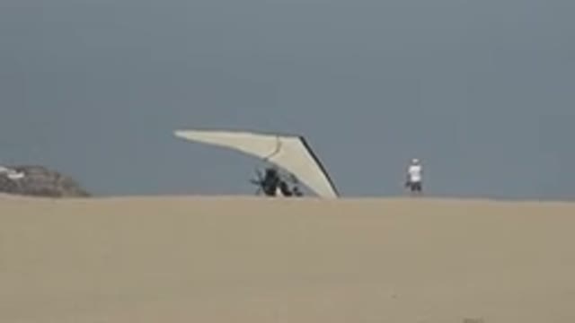 LOS CABOS MEXICO-2019: A Person Standing At The Top Of A Hill With A Hang Glider