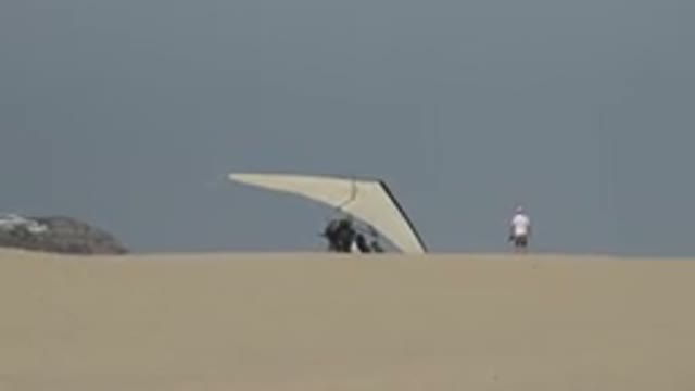 LOS CABOS MEXICO-2019: Men Preparing To Ride A Hand-Glider While His Friends Watch
