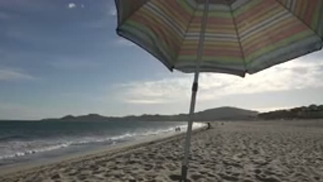 LOS CABOS MEXICO-2019: Umbrella On The Beach Being Shaken By The Strong Wind