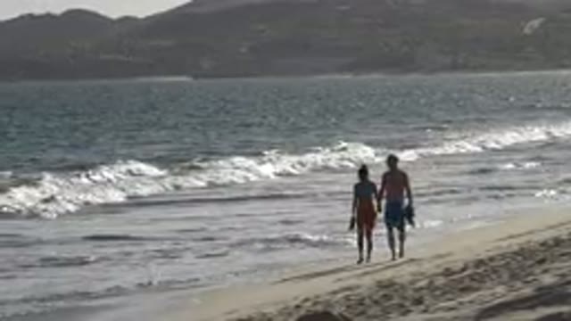 LOS CABOS MEXICO-2019: A White Man And Woman Walk On A Beach In The Daytime