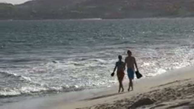 LOS CABOS MEXICO-2019: Fit Couple Hold Hands And Take A Stroll On The Sunny