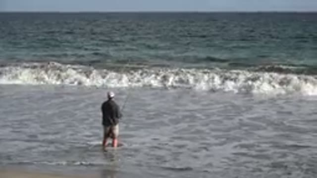 LOS CABOS MEXICO-2019: Fishing Man Fishing On The Seashore With A Fishing Rod