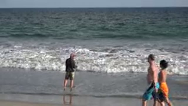 LOS CABOS MEXICO-2019: Man Fishing On Shore With Couple Walking
