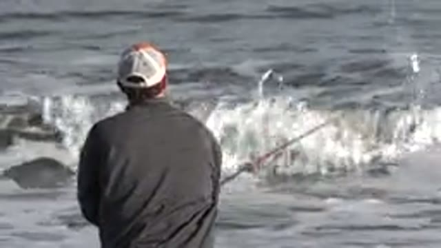 LOS CABOS MEXICO-2019: Man Fishing On Beach With Waves On Sunny Day