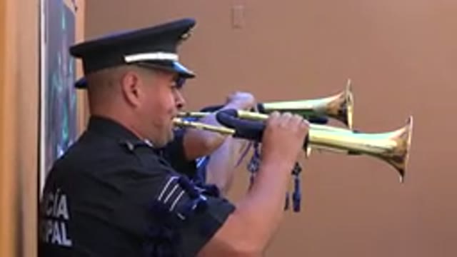 SAN JOSE DEL CABO MEXICO-2019: Police Officer Playing Trumpet in Public Performance