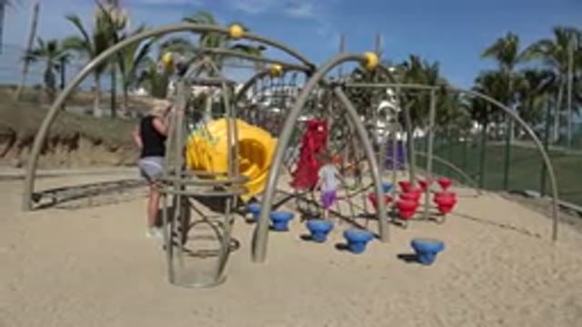 SAN JOSE DEL CABO MEXICO-2019: Mum Watches Son And Daughter Playing In Yellow Tunnel