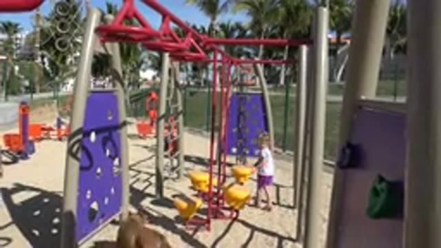 SAN JOSE DEL CABO MEXICO-2019: Small Child Wearing White Shirt Climbs Purple Object