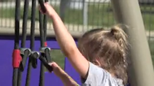 SAN JOSE DEL CABO MEXICO-2019: Blonde Child Climbs Black Rope Climbing Frame
