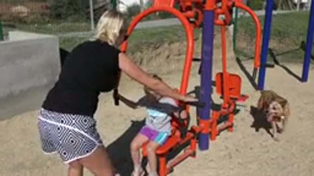 SAN JOSE DEL CABO MEXICO-2019: Woman Helps Little Girl Play On Outdoor Equipment