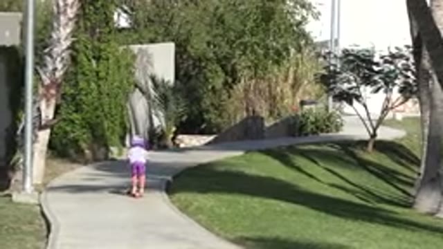 SAN JOSE DEL CABO MEXICO-2019: A Small Child In Purple Riding A Scooter With A Helmet