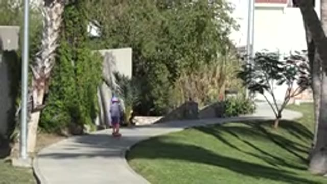 SAN JOSE DEL CABO MEXICO-2019: Child Playing With Scooter On Sidewalk