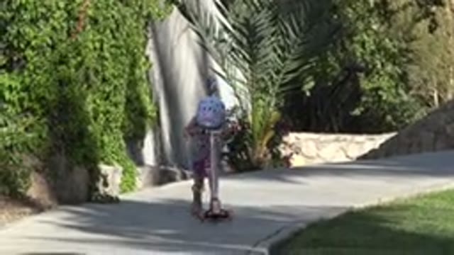SAN JOSE DEL CABO MEXICO-2019: A Little Girl Rides Her Scooter Down Small Incline