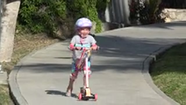 SAN JOSE DEL CABO MEXICO-2019: A Happy Child Rides Her Scooter For The First Time