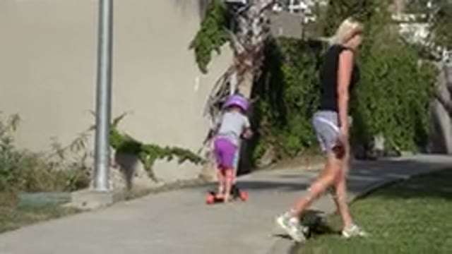 SAN JOSE DEL CABO MEXICO-2019: Woman Wearing Black Shirt Watches Girl Wearing Purple Shorts