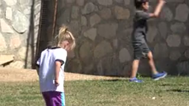 SAN JOSE DEL CABO MEXICO-2019: A Girl Walks Barefoot on a Grassy Field