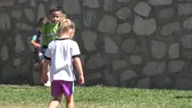 SAN JOSE DEL CABO MEXICO-2019: Girl Wearing White Shirt Runs On Green Field On A