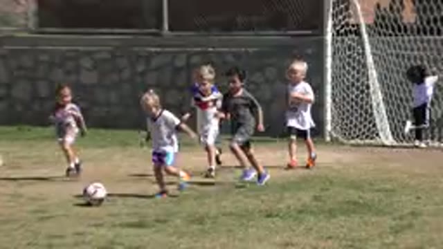SAN JOSE DEL CABO MEXICO-2019: Several Kids Playing Soccer On A Lawn With Two