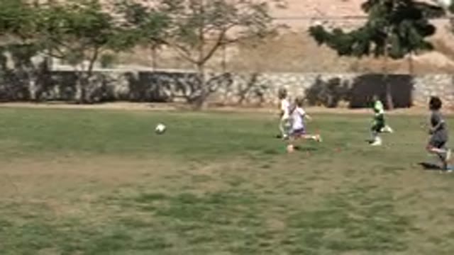SAN JOSE DEL CABO MEXICO-2019: Little Girl Waves To The Camera While Playing Football