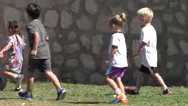 SAN JOSE DEL CABO MEXICO-2019: Girl Wearing Tan And Black Shoes Picks Up Ball On