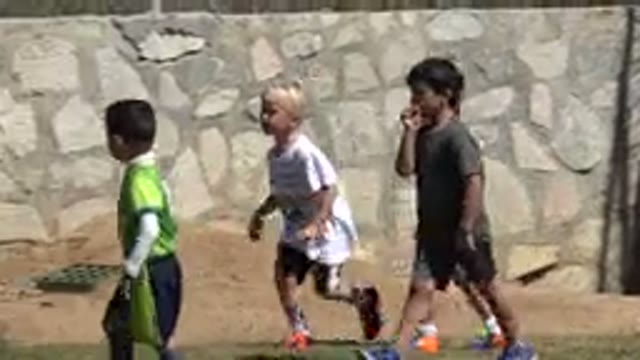 SAN JOSE DEL CABO MEXICO-2019: Little Girl Chases After a Group of Boys Who Run