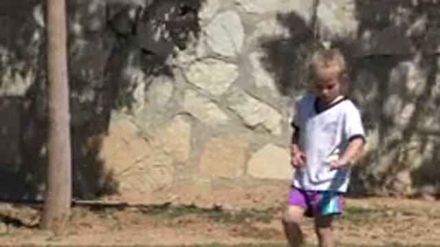 SAN JOSE DEL CABO MEXICO-2019: Child Walking on Beach Wearing White Shirt and Purple Shorts