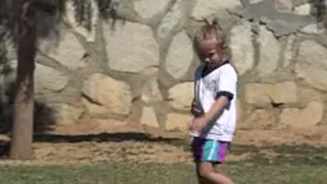 SAN JOSE DEL CABO MEXICO-2019: Blonde-Haired Girl Smiles and Gestures Toward Camera