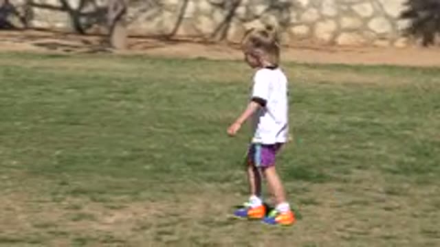 SAN JOSE DEL CABO MEXICO-2019: Young Female Child Walks on Dry Grass Near Trees