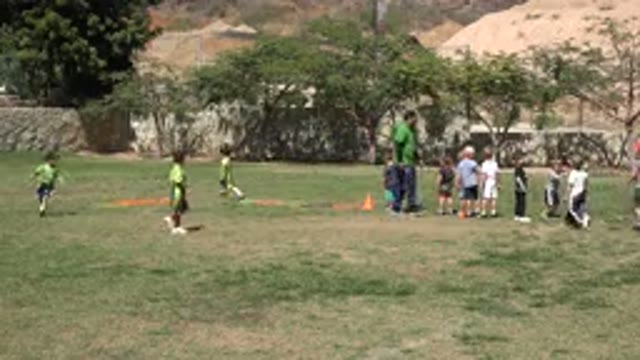 SAN JOSE DEL CABO MEXICO-2019: Man Training A Team Of Children In A Field To