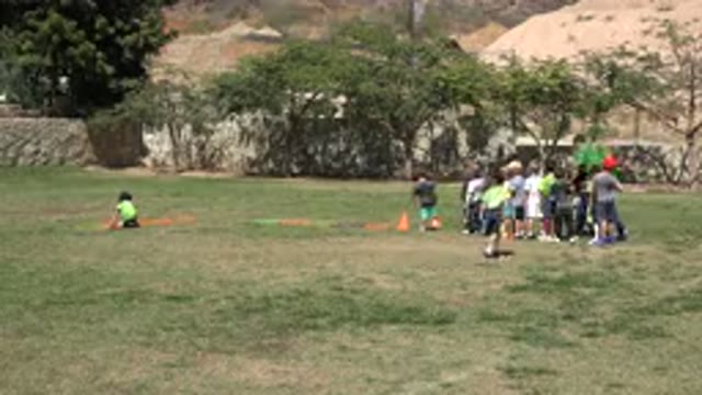 SAN JOSE DEL CABO MEXICO-2019: Boy Wearing Green Shirt With Black Shorts Runs
