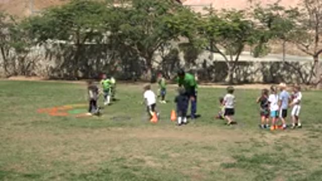 SAN JOSE DEL CABO MEXICO-2019: Footage Of A Coach Training Kids In An Athletic Field