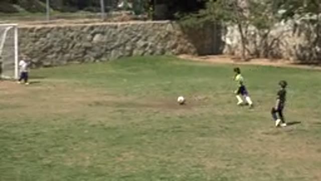 SAN JOSE DEL CABO MEXICO-2019: Boy Wearing Green Shirt With White Socks Kicks Ball