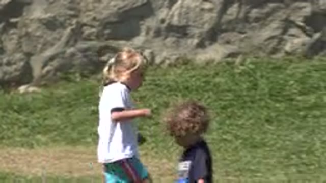 SAN JOSE DEL CABO MEXICO-2019: A Group of Kids Playing Soccer on a Grassy Field
