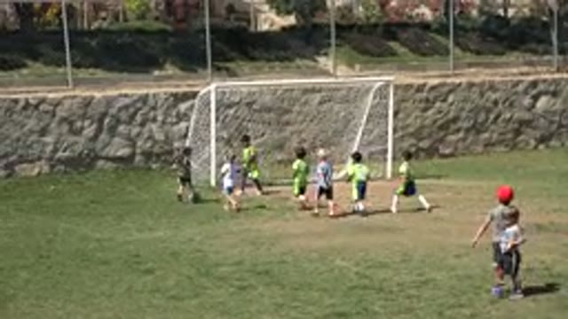 SAN JOSE DEL CABO MEXICO-2019: Boy Wearing Green Shirt And White Shoes Picks Up Soccer Ball