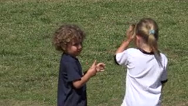 SAN JOSE DEL CABO MEXICO-2019: Two Kids Playing In A Green Park With A Green Lawn