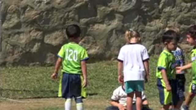SAN JOSE DEL CABO MEXICO-2019: Girl Tries To Help Fallen Boy On Soccer Field