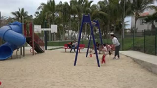 SAN JOSE DEL CABO MEXICO-2019: Children Playing In The Park On The Swing Under