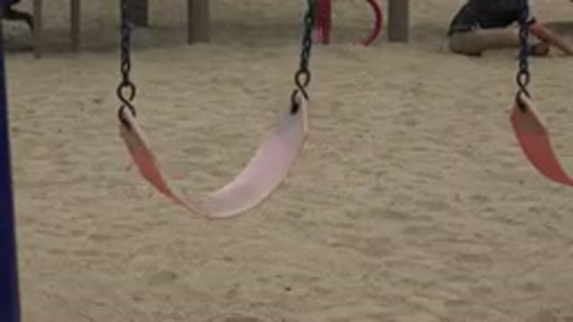 SAN JOSE DEL CABO MEXICO-2019: Empty Swing Slowing Moving Back And Forth In The Park