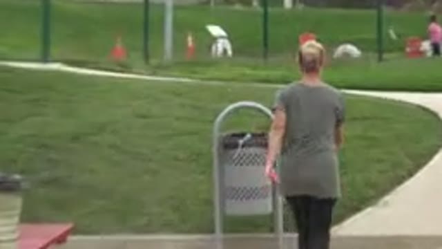SAN JOSE DEL CABO MEXICO-2019: Woman Picks Toy Out A Receptacle At Dog Park